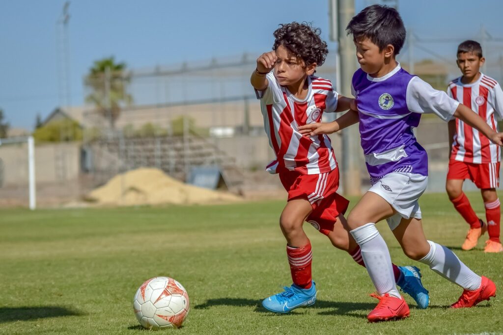 Image of kids playing football together